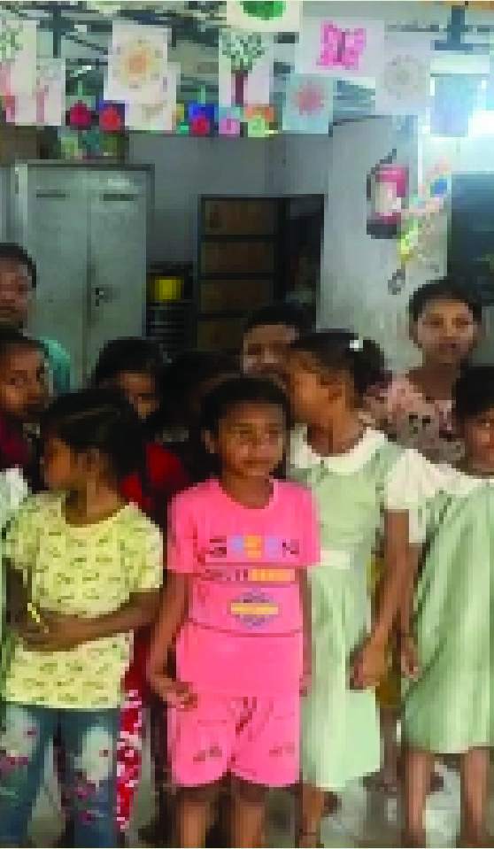 Children waiting at a community centre during a Green Closet handover