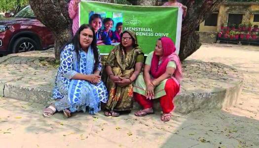 Women seated together at a village menstrual awareness drive